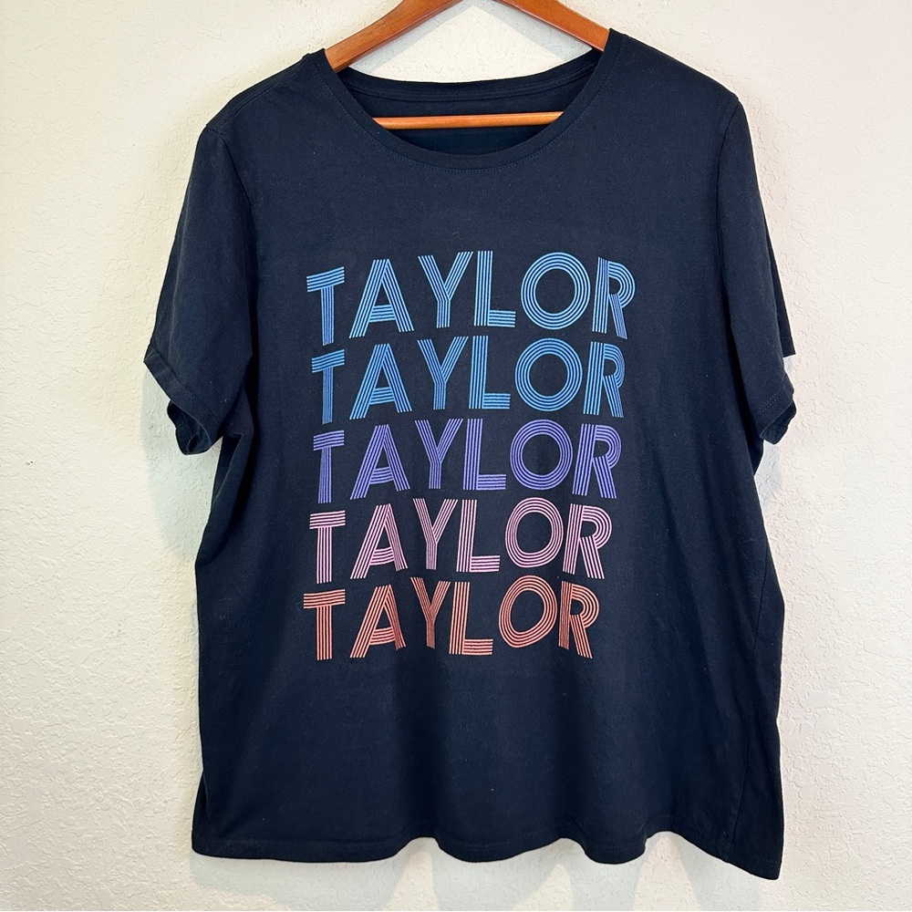 Taylor Swift Black Graphic Tee with repeated Multicolor Text